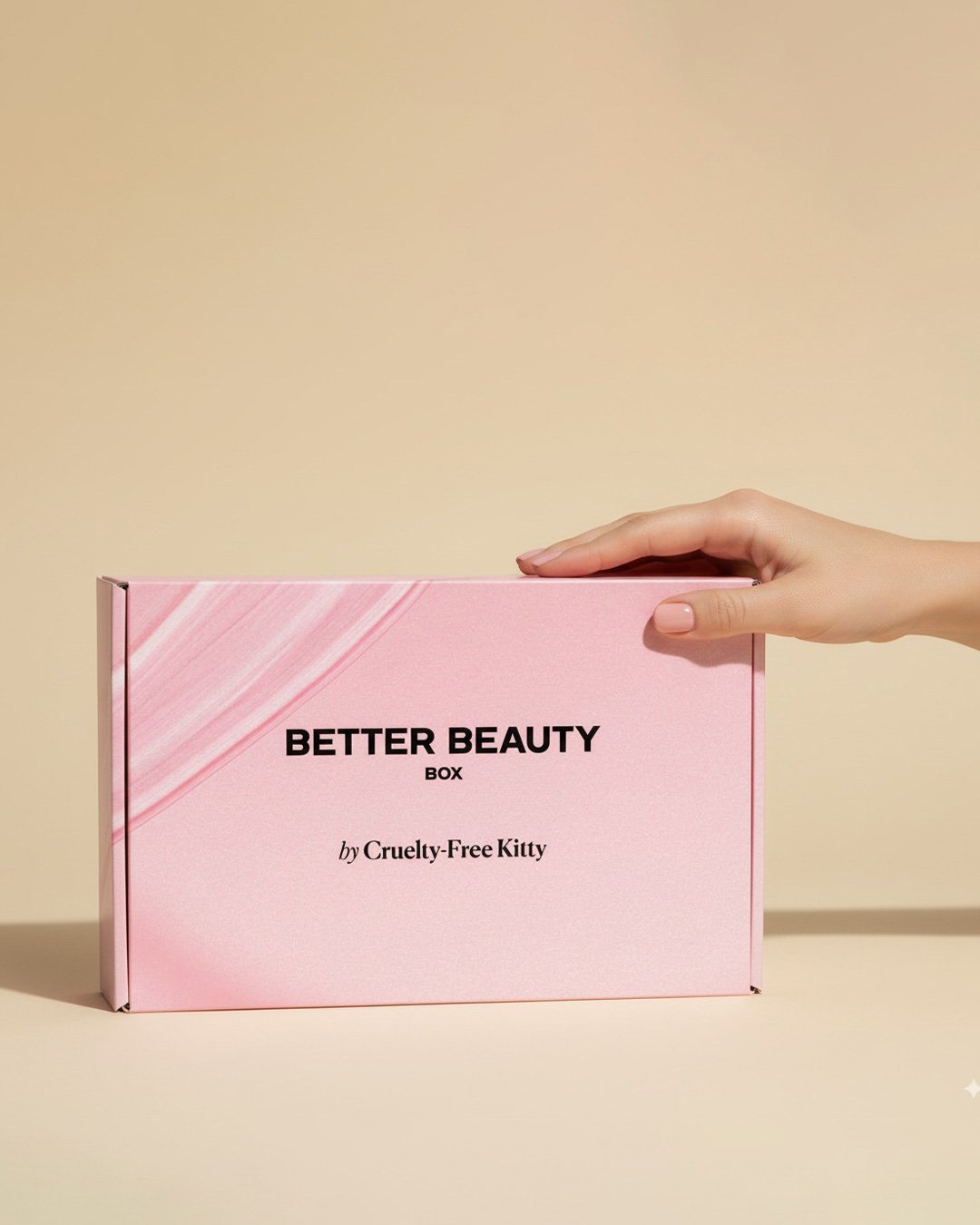 A pink beauty subscription box with products elegantly displayed around it.